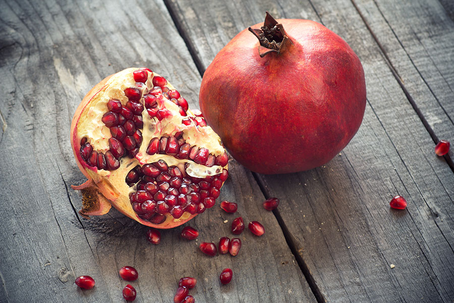 Pomegranate on wooden surface – visual for Executive Jobs page at The Talent Solution
